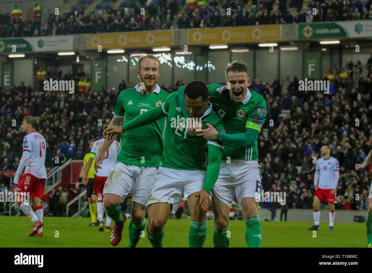 National Football Stadium at Windsor Park, Belfast, Northern Ireland. 24  March 2019. UEFA EURO 2020 Qualifier- Northern Ireland v Belarus. Action from tonight's game. Josh Magennis (21) celebrates his winner for Northern Ireland with Steven Davis (8) and Liam Boyce (9). Credit: David Hunter/Alamy Live News. Stock Photo