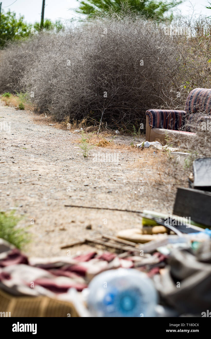 Sofa thrown away in natural area forest part illegal dumping trash