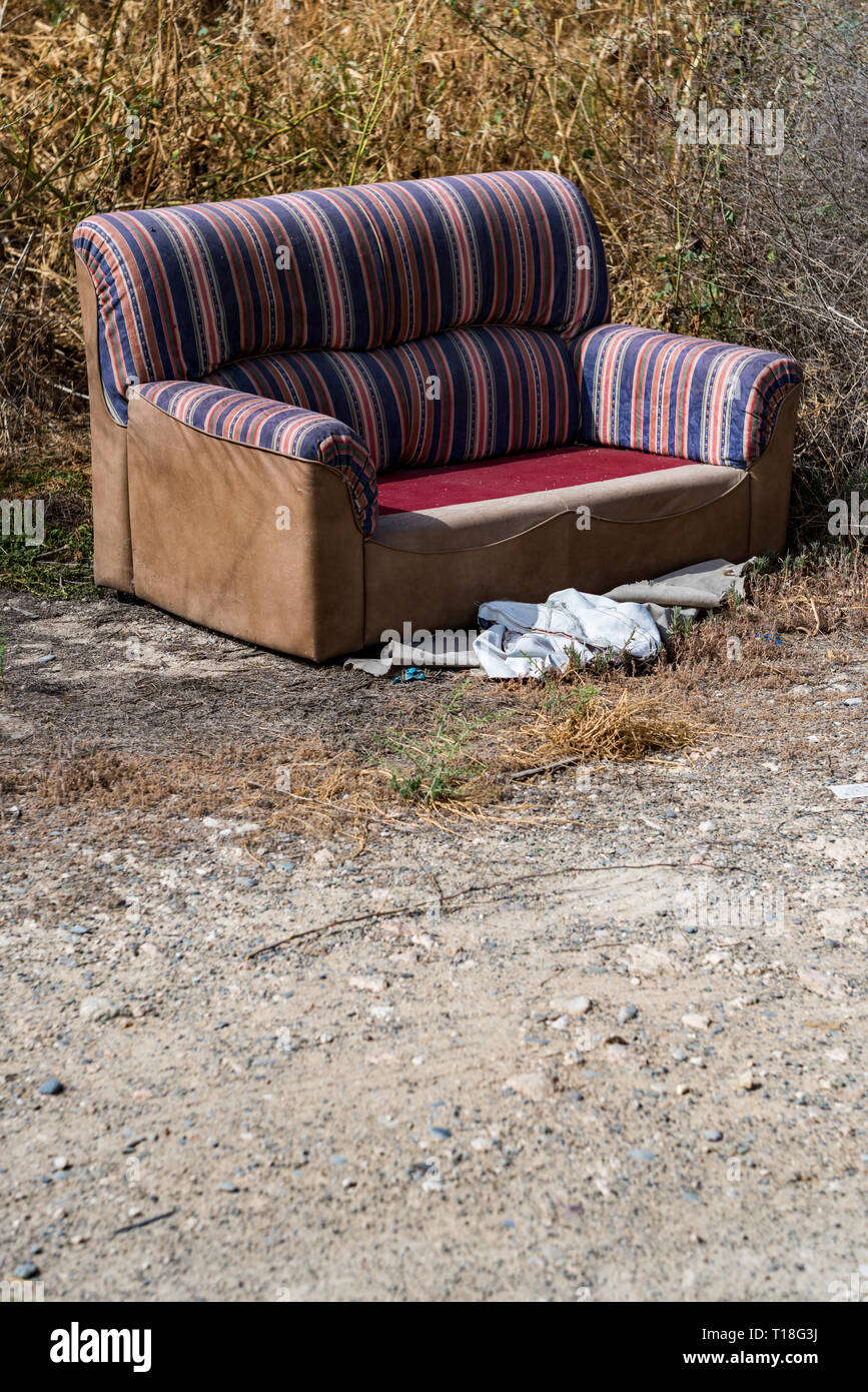 https://c8.alamy.com/comp/T18G3J/sofa-thrown-away-in-natural-area-forest-part-illegal-dumping-trash-in-nature-ecology-T18G3J.jpg