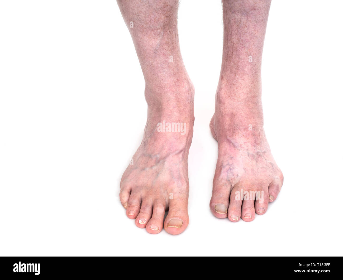 Female touching feet while doing yoga in health club Stock Photo