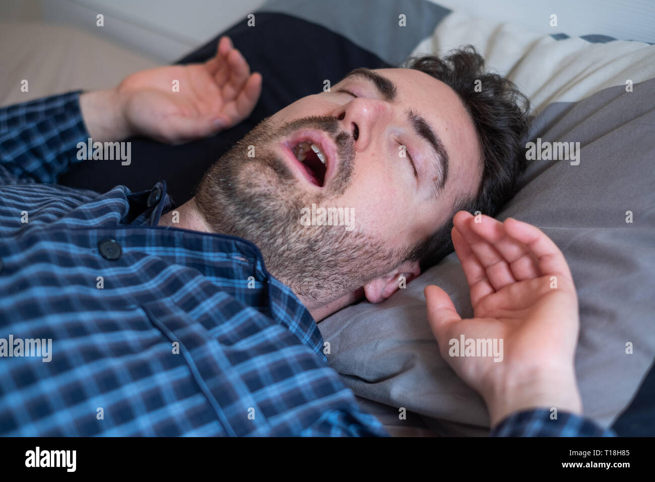 Man with snoring problem sleeping in bed Stock Photo Alamy