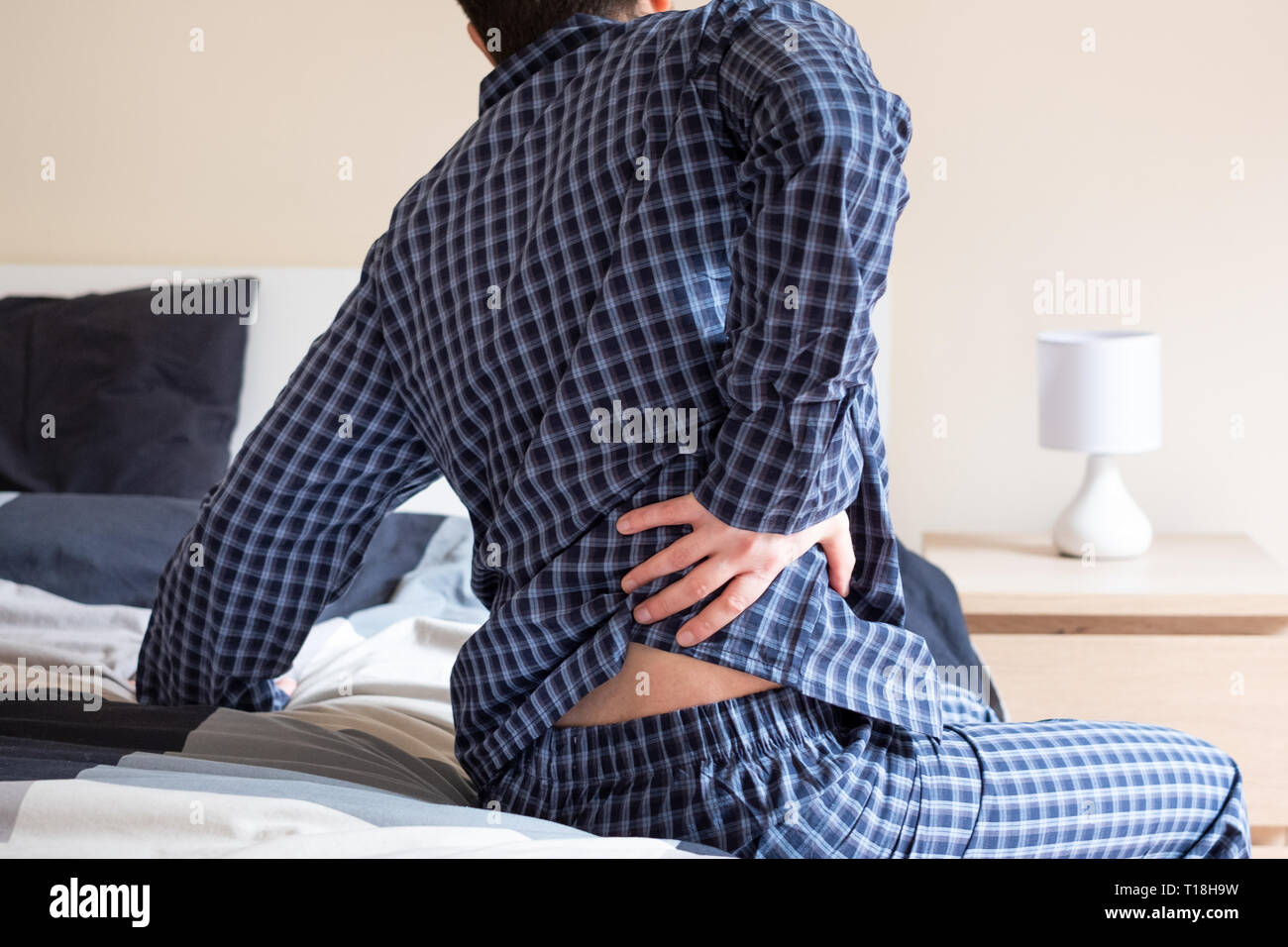 Back pain problem in the morning concept Stock Photo Alamy
