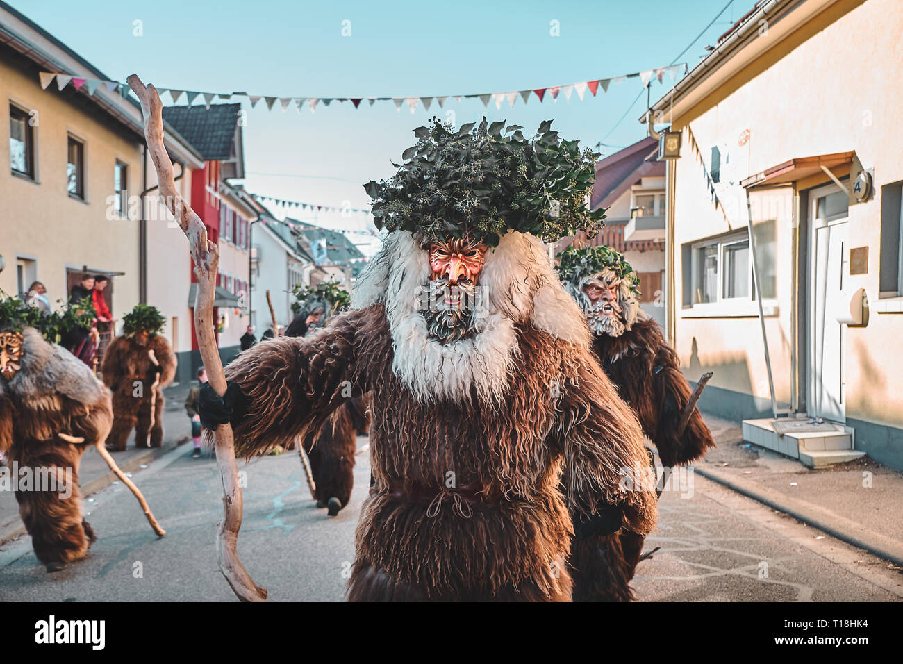 Haired wild man posing in front of the camera. Carnival party in southern Germany - Black Forest. Stock Photo