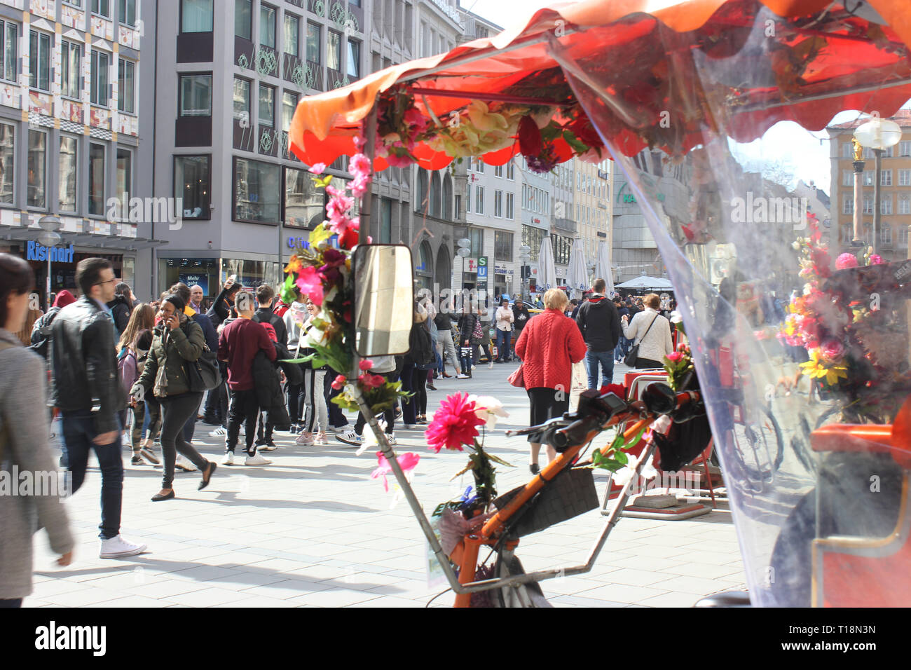 Rickshaw in crowded pedestrian area of Munich, waiting for customers on a busy Friday. Stock Photo