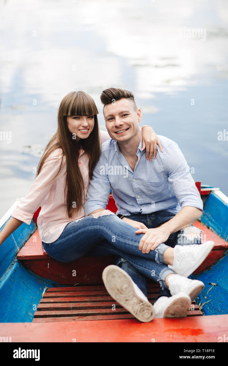 A couple riding a blue boat on a lake. romance. emotional couple Stock ...