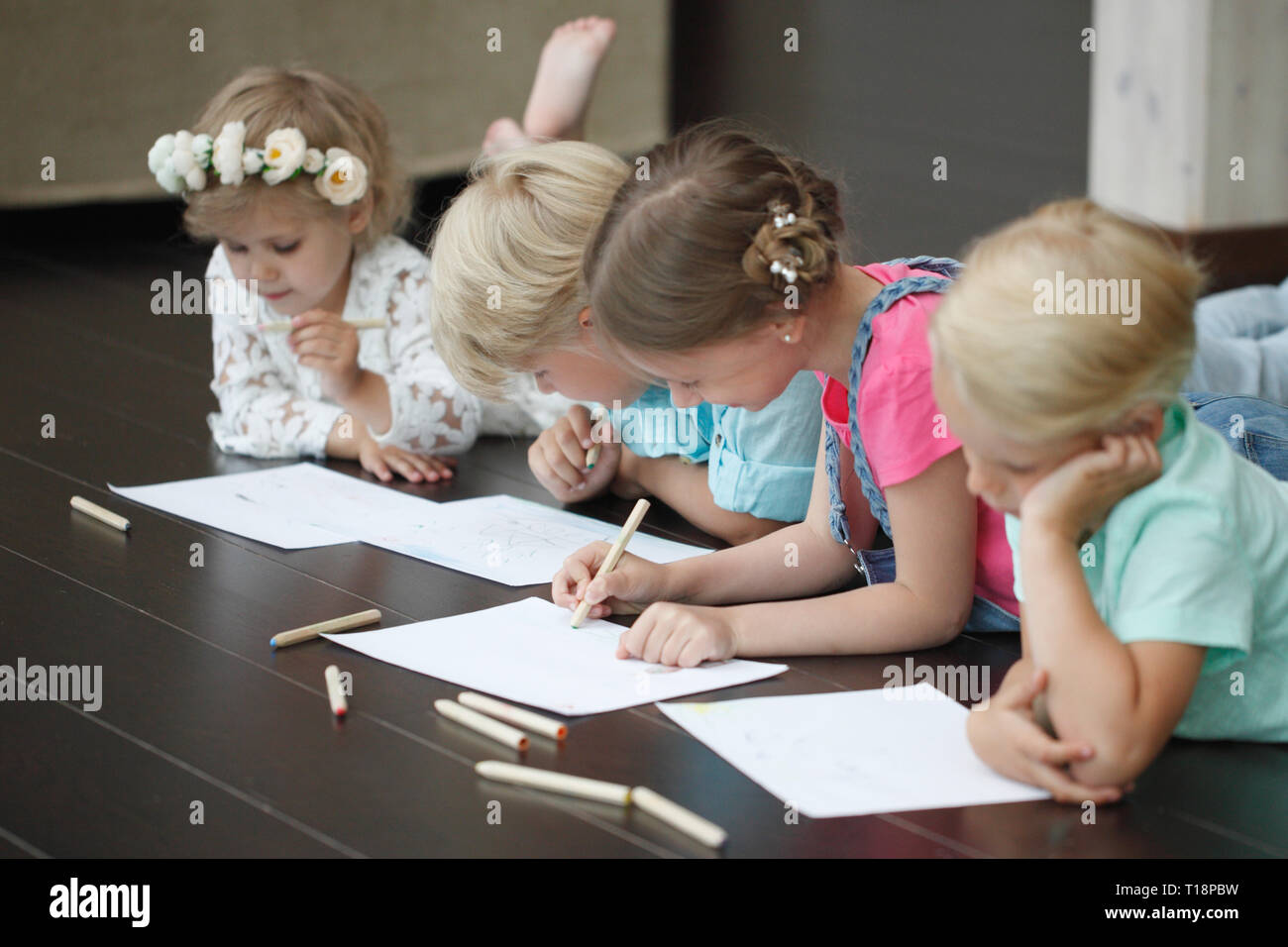 Group of cute children drawing with colorful pencils on floor Stock ...