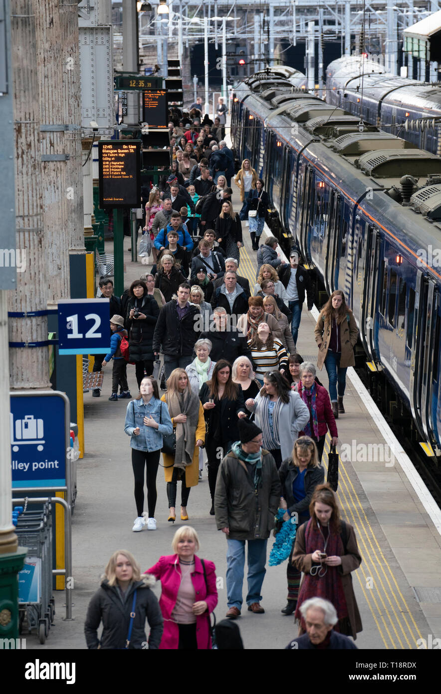 Passengers disembark onto platform from Scotrail train  at Waverley Station iN Edinburgh, Scotland, UK Stock Photo