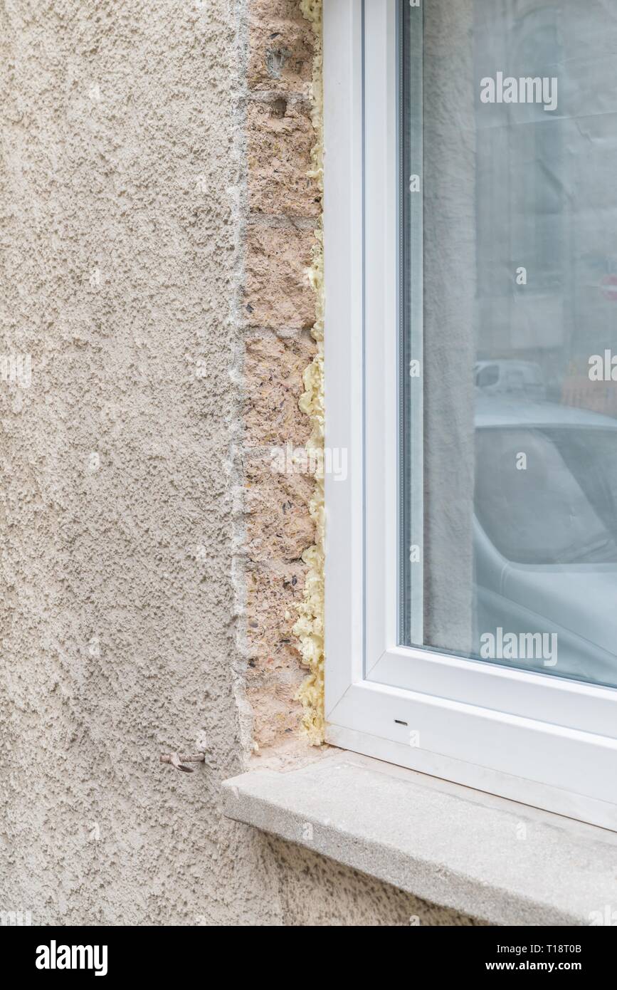 Close-up of a window in the shell with construction foam and window ...