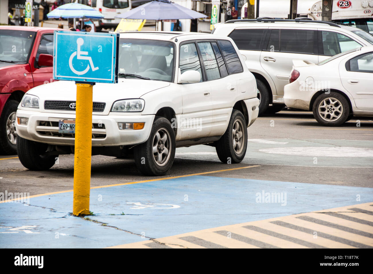 Handicapped parking space in a parking lot in the city of Ensenada, Mexico. Stock Photo