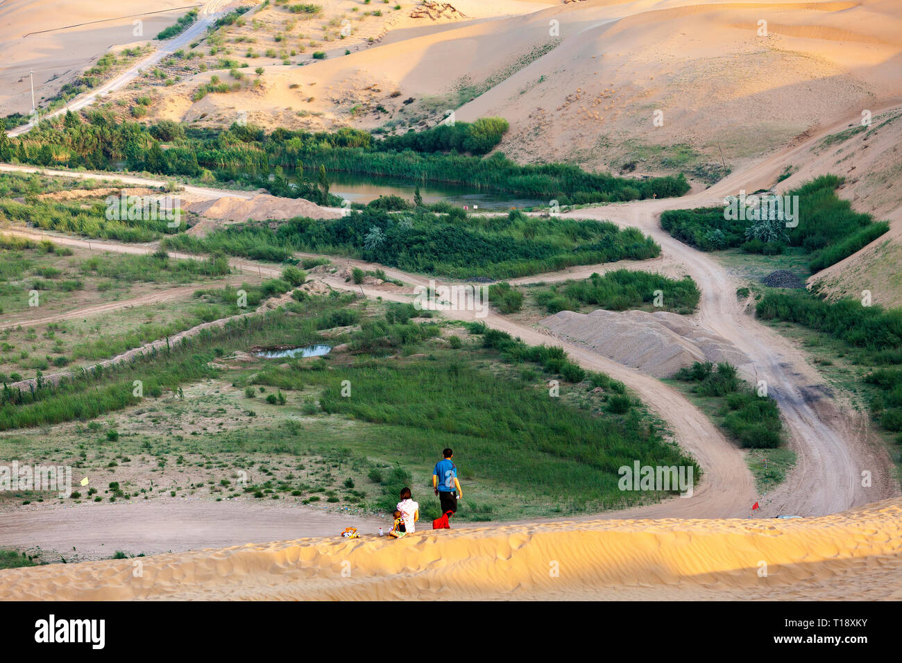 A young family enjoying the view of Kubuqi desert in the Ordor A young family enjoying the view of Kubuqi desert in the Ordor