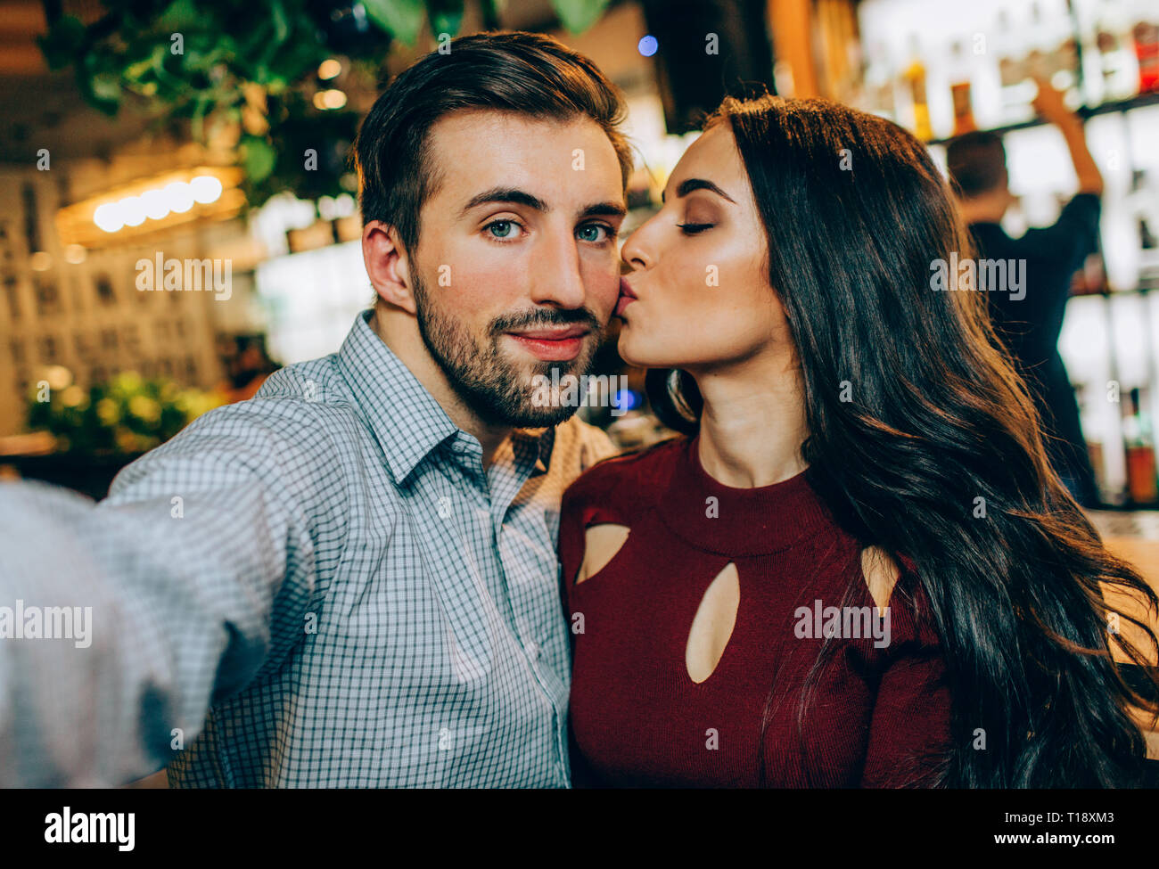 Another Selfie Of Couple Girl Is Kissing Her Partner While He Is Taking A Picture They Look