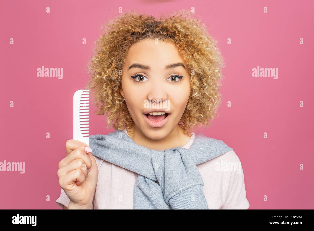 Portrait Of A Girl With Curly Hair She Is Holding A Small White
