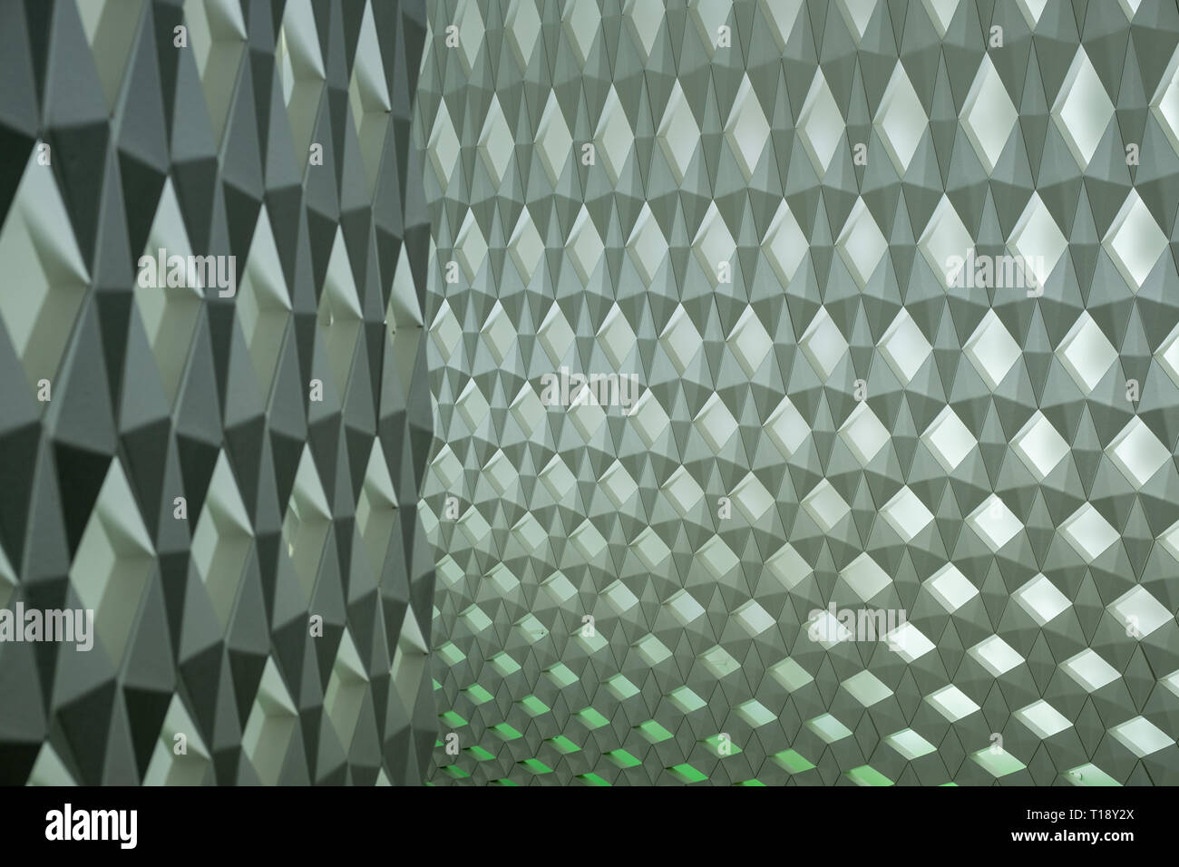 Geometric wall pattern with green background lights Stock Photo