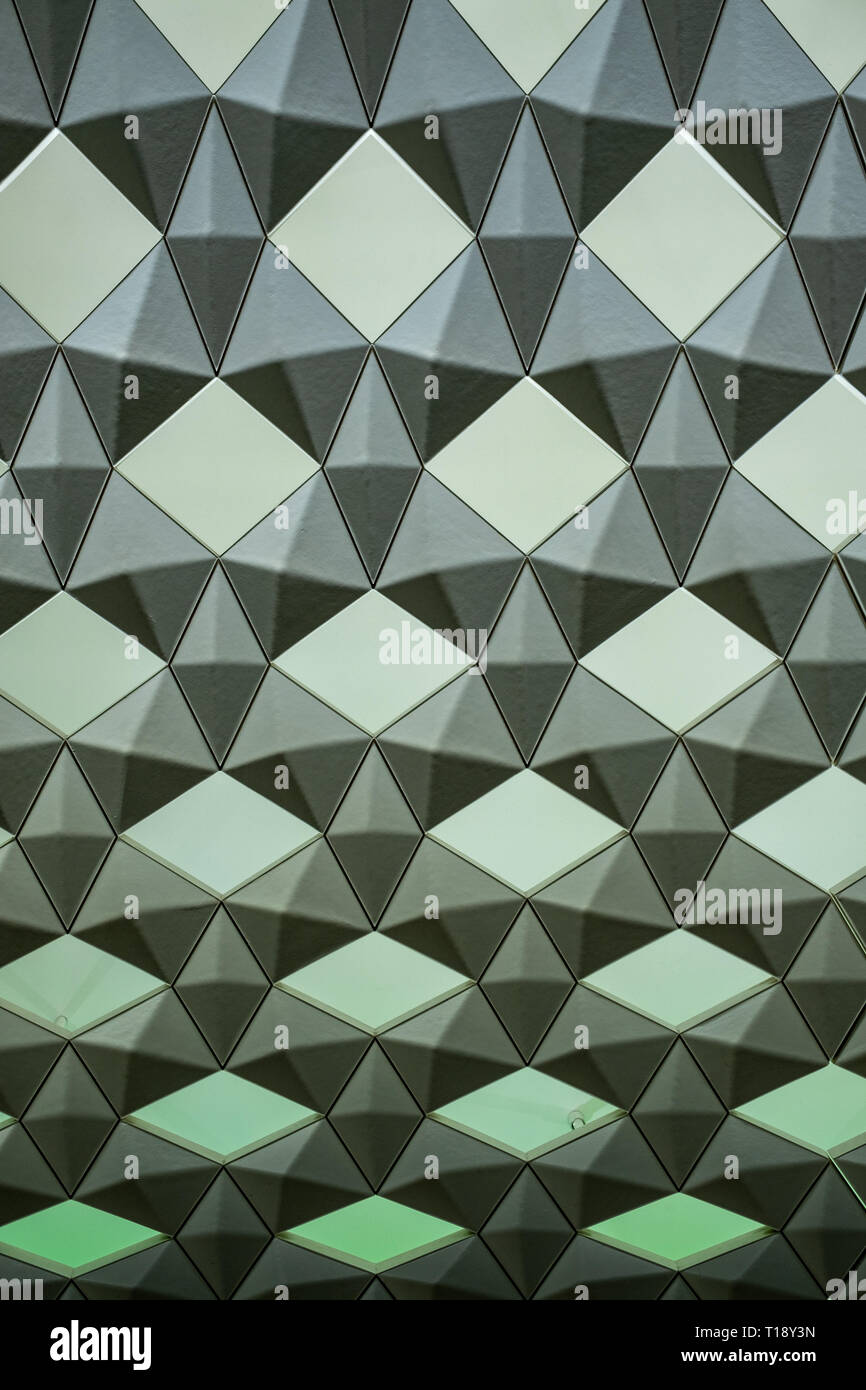 Geometric wall pattern with green background lights Stock Photo
