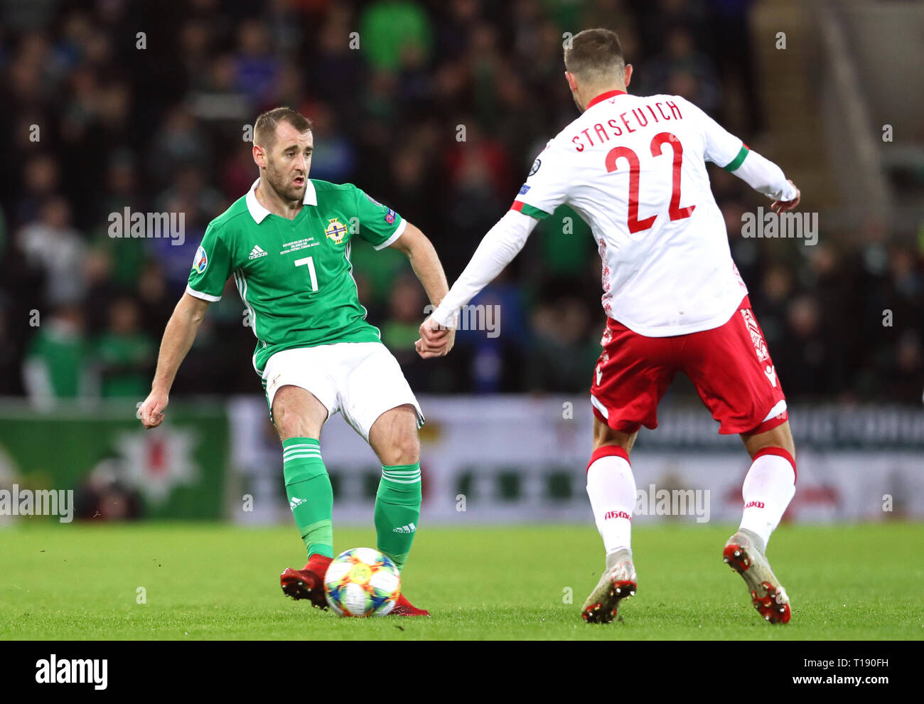 Northern Ireland's Niall McGinn (left) and Belarus' Ihar Stasevich battle for the ball during the UEFA Euro 2020 Qualifying, Group C match at Windsor Park, Belfast. Stock Photo