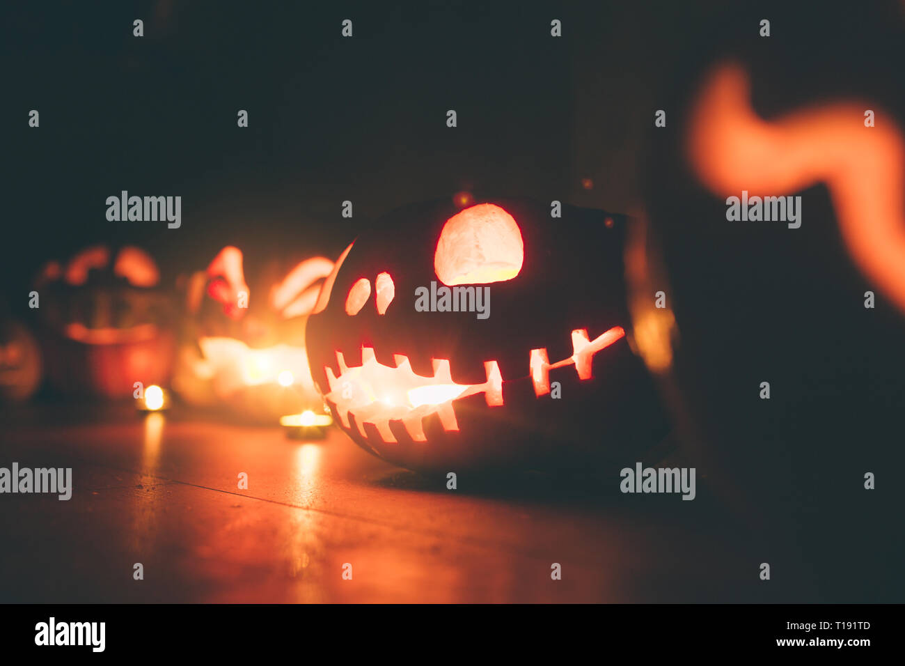 Ghost pumpkins on Halloween. ead Jack on Dark background. Holiday indoor decorations. Stock Photo