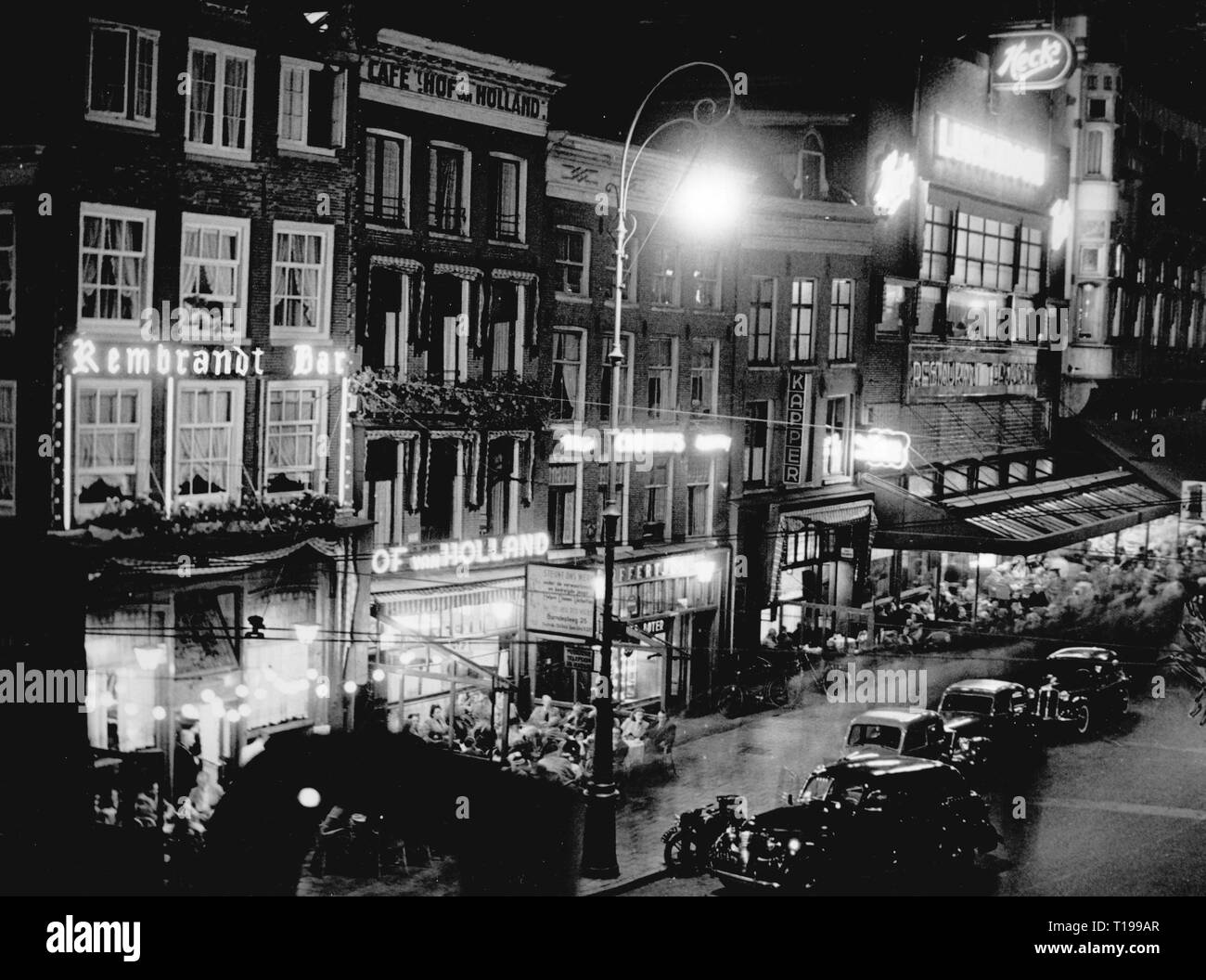geography / travel, Netherlands, Amsterdam, square, Rembrandtplein, at night, 1950s, night shot, nights, building, buildings, facade, facades, gastronomy, cafe, cafes, street lamp, street-lamp, street light, street lamps, street-lamps, street lights, lantern, lamp, lanterns, lamps, luminous advertising, neon sign, neon signs, street, streets, car, cars, Holland, Benelux, Benelux country, Benelux state, Benelux countries, Benelux states, Western Europe, Europe, architecture, bar, bars, pub, pubs, tavern, taverns, square, squares, at night, by nigh, Additional-Rights-Clearance-Info-Not-Available Stock Photo