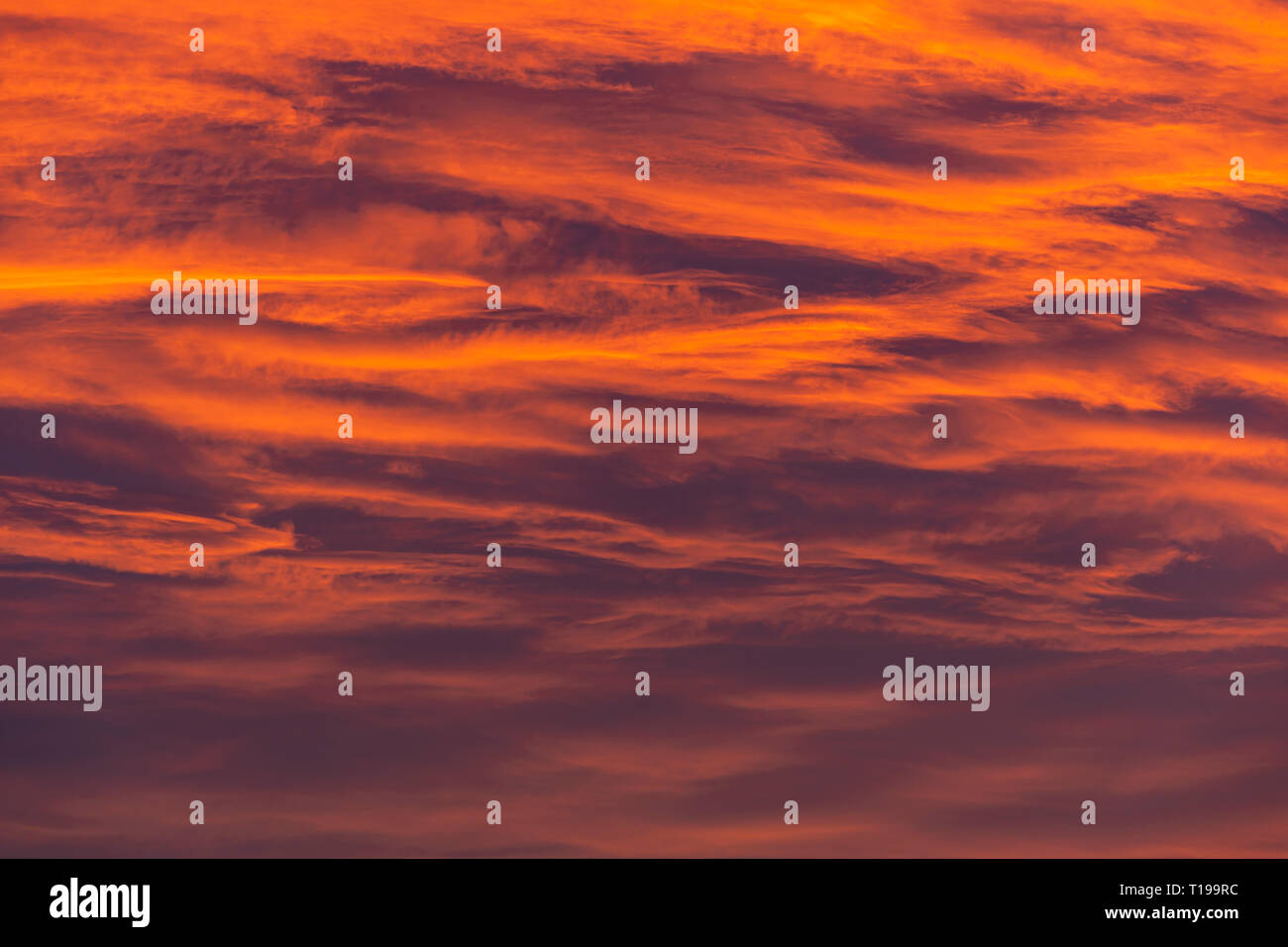 Glowing sunset sky with sureal deep orange and dark blue colors. Stock Photo