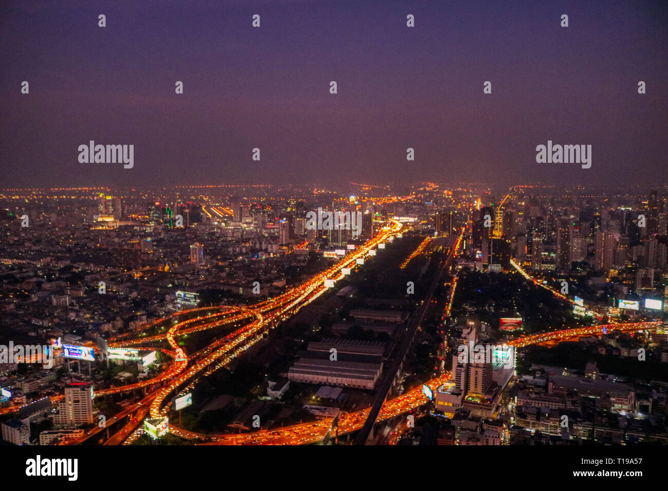 This unique photo shows the spectacular  Bangkok Thailand by night. You can see how the city in the evening sun lights up with a great cloud Stock Photo