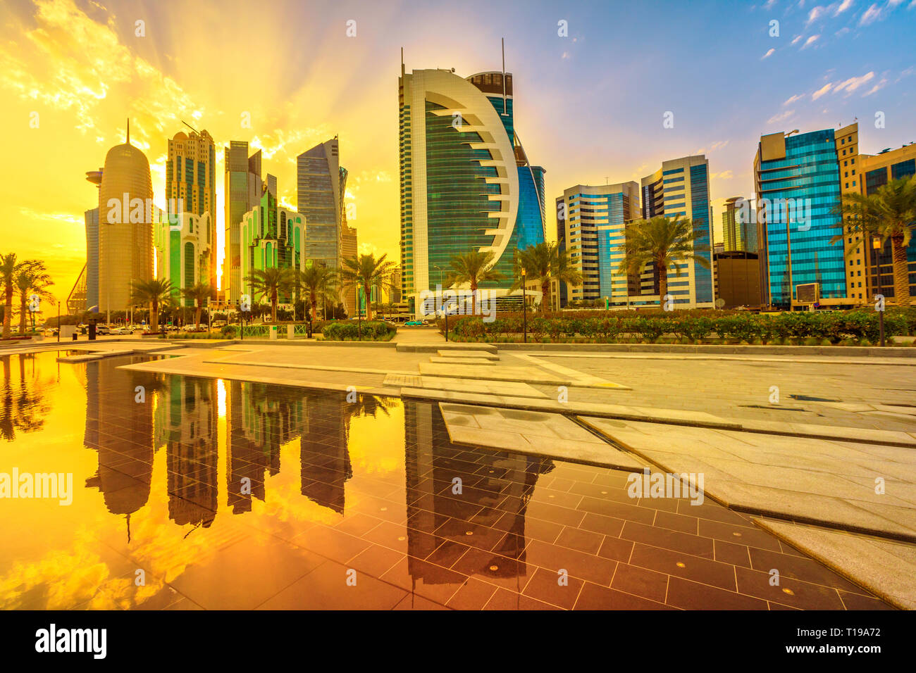 Beautiful cityscape of Doha West Bay skyline at sunset sky reflections in Downtown Park. Modern glassed towers of Doha in Qatar, Middle East, Arabian Stock Photo