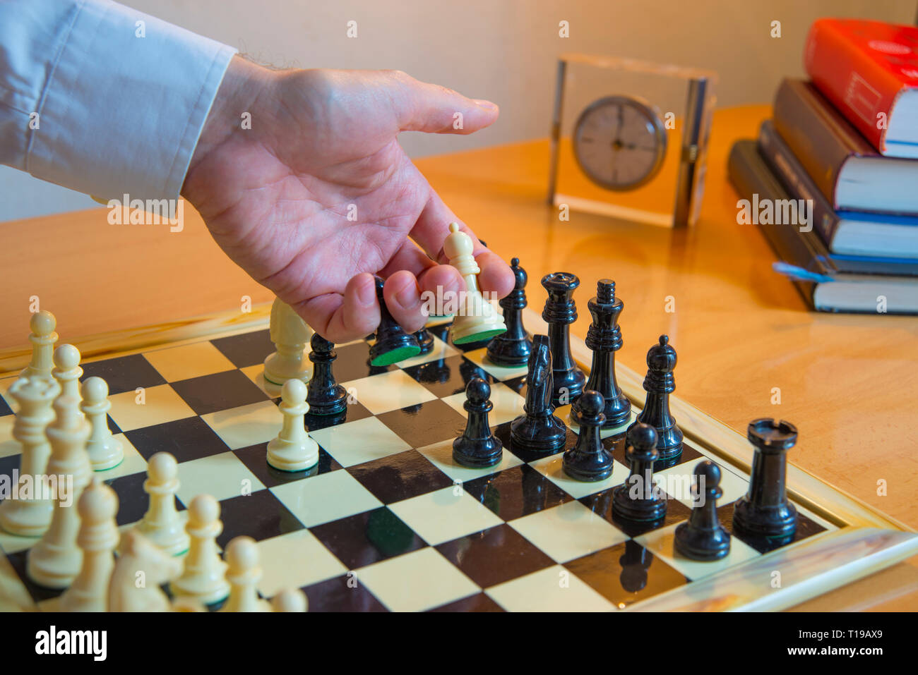 Man's hand playing chess. Stock Photo