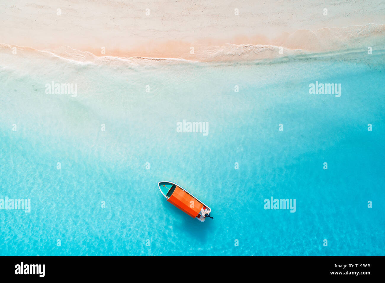 Aerial view of the fishing boats in clear blue water at sunny day in ...