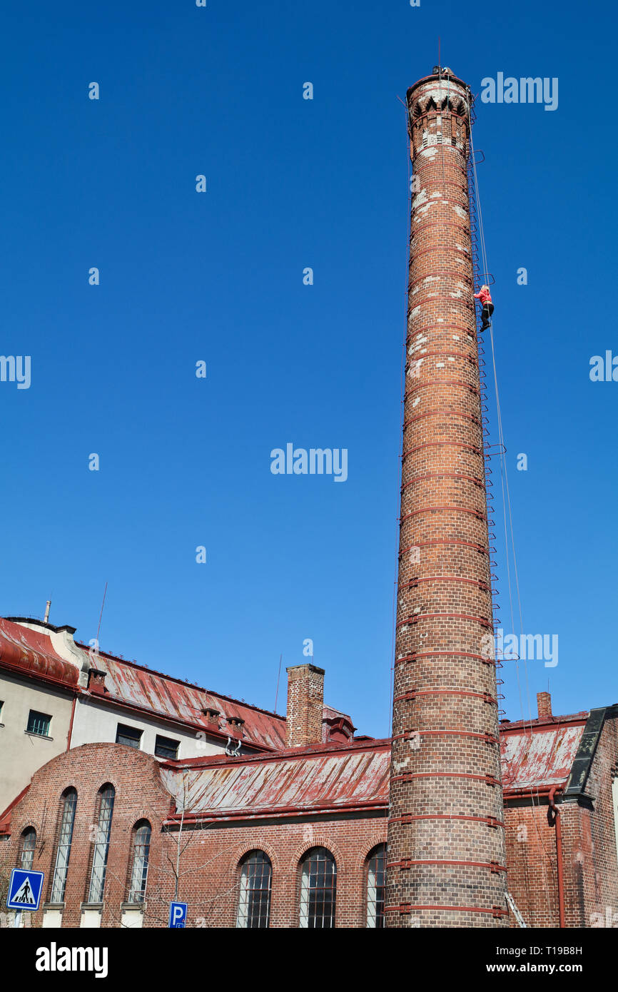 Cimbing the old factory chimney Stock Photo