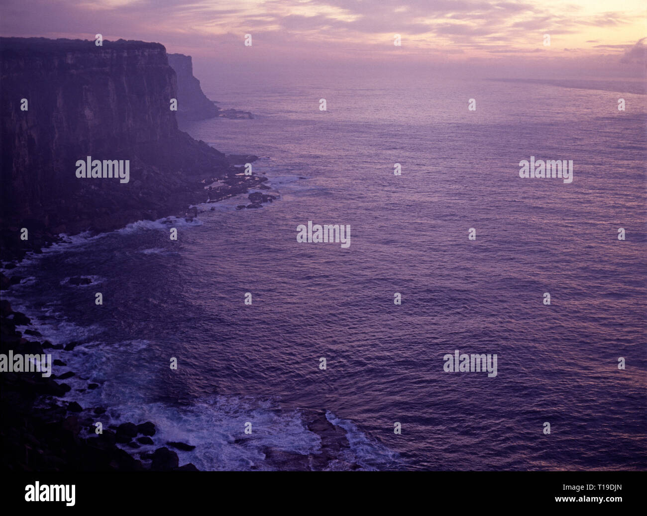 Australia. New South Wales. Sunrise over the sea with headland cliffs. Stock Photo