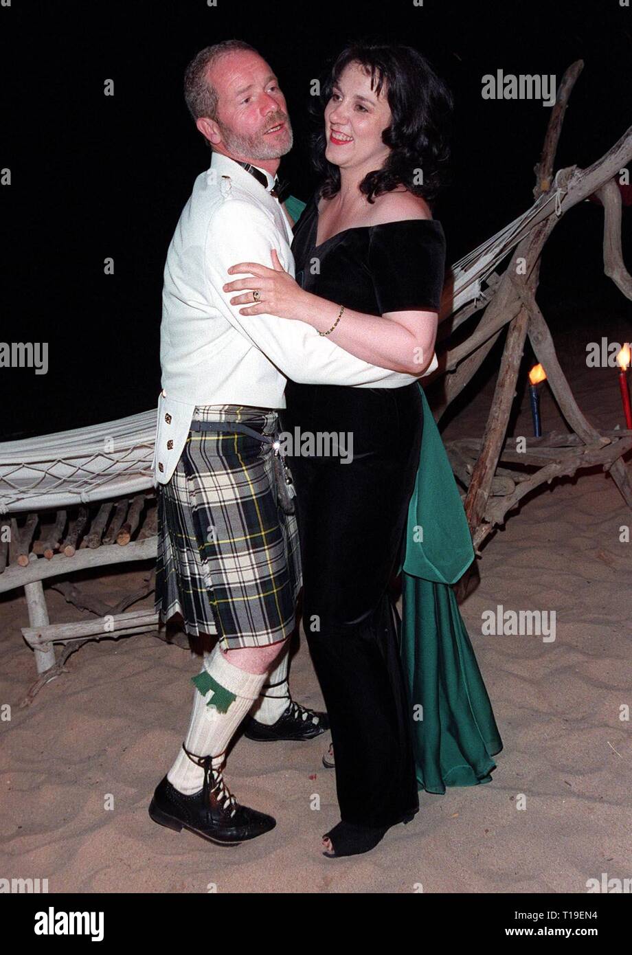 CANNES, FRANCE - May 24, 1998:  Cannes Best Actor winner PETER MULLAN celebrates his award by dancing on the beach with his wife ANNIE. Stock Photo