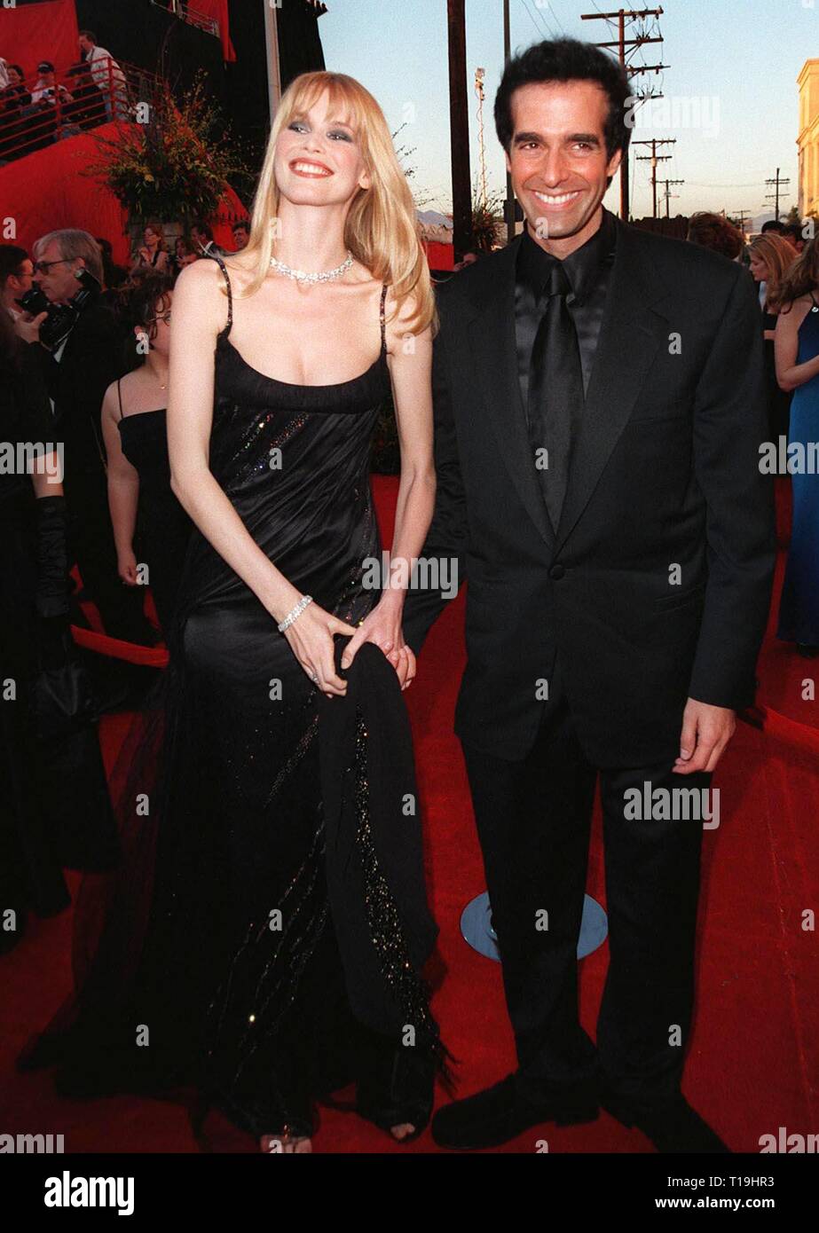 LOS ANGELES, CA - March 23, 1998: Supermodel CLAUDIA SCHIFFER & magician DAVID COPPERFIELD at the 70th Academy Awards. Stock Photo