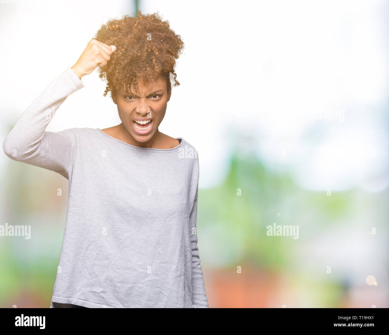 Angry young woman raising hand hi-res stock photography and images - Alamy