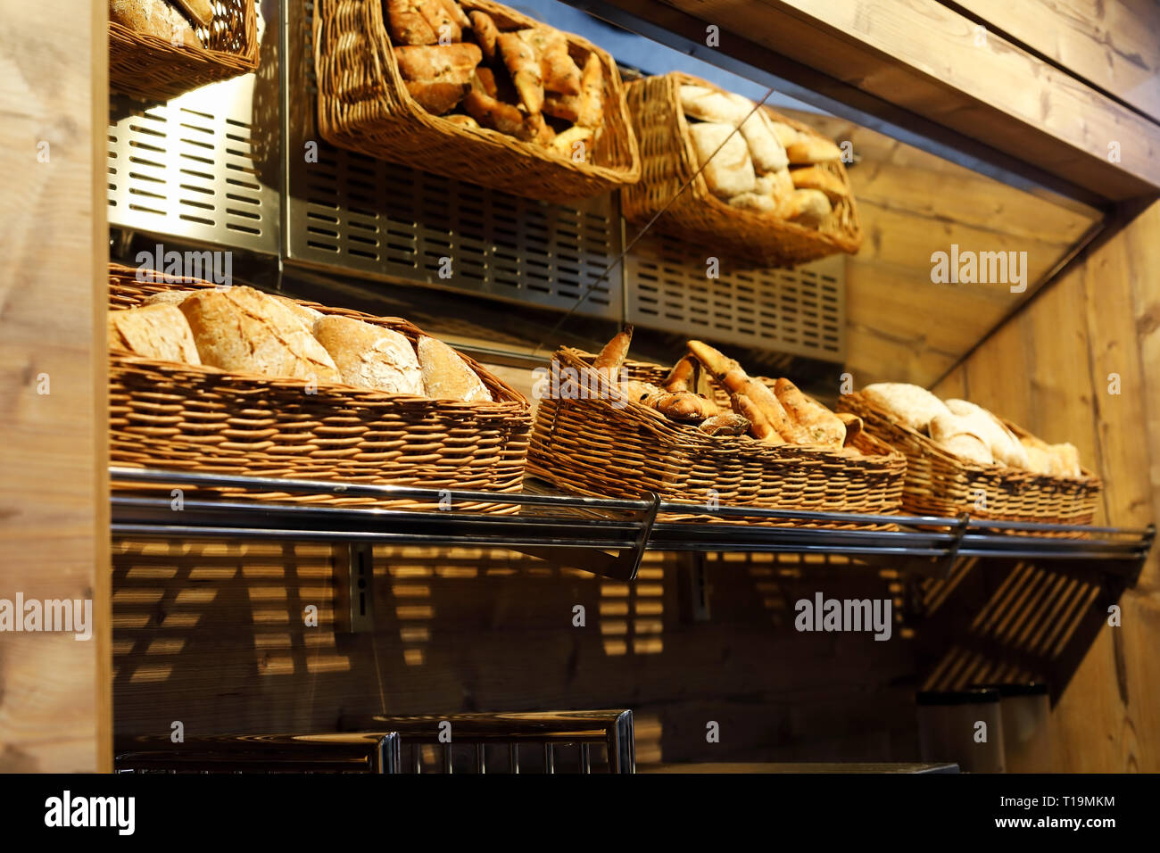 Baskets with different types of bread on the shelf in the bakery shop Stock Photo Alamy