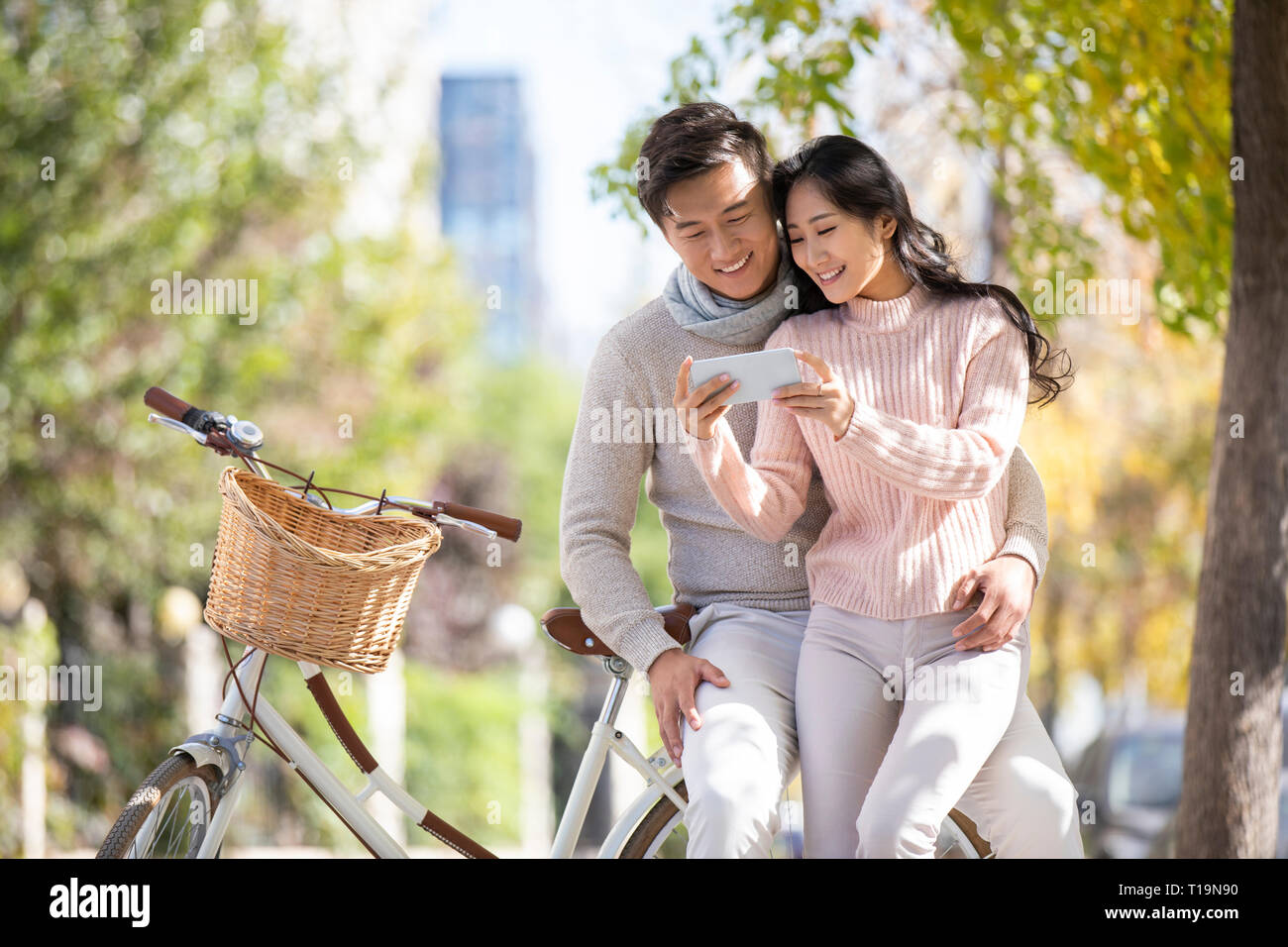 Happy young couple using smartphone Stock Photo