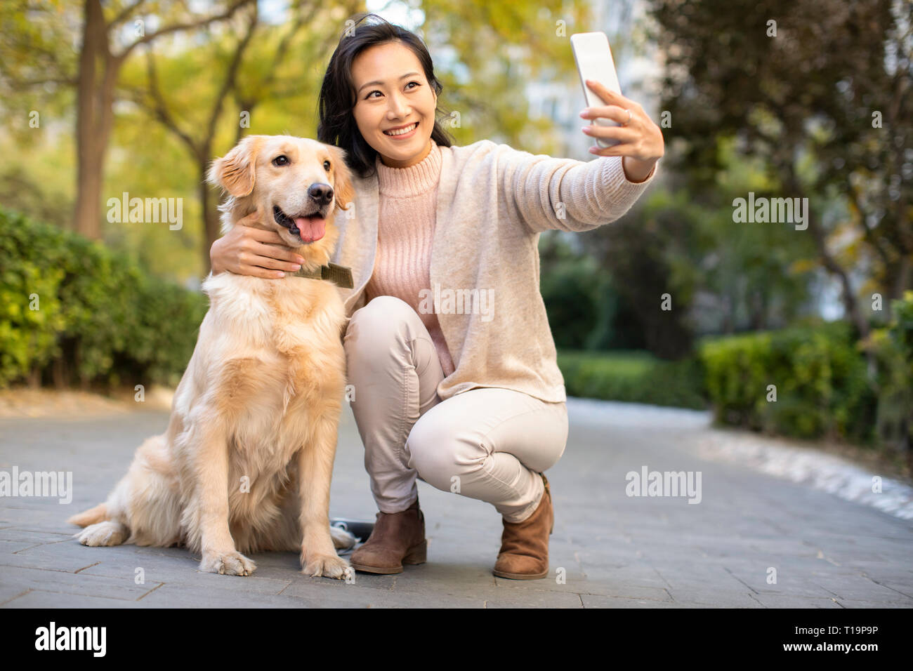 Happy young woman taking a selfie with her dog Stock Photo - Alamy