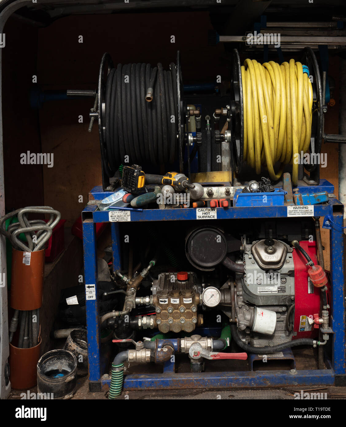 Pressure cleaning equipment and other tools in the back of a van in