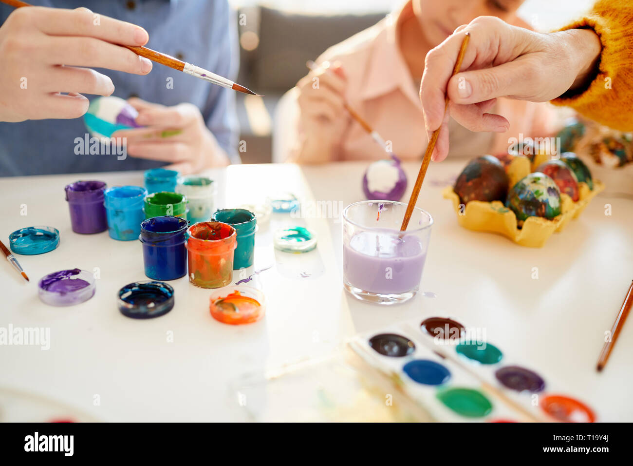 Family Painting Eggs for Easter Close Up Stock Photo