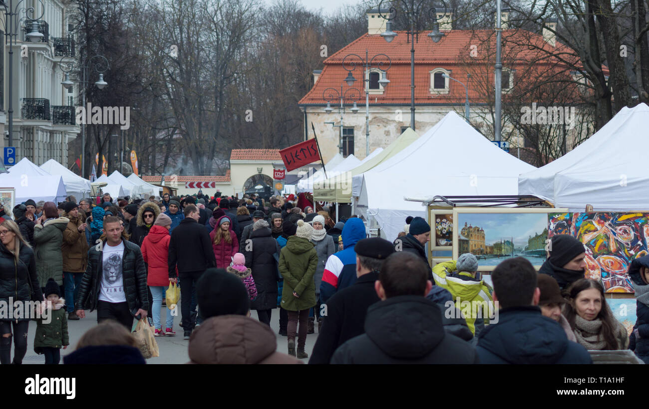 Vilnius/Lithuania - March 3, 2019: St. Casimir's Fair. Multitude of people enjoying fair. A red flag visible in distance. Stock Photo