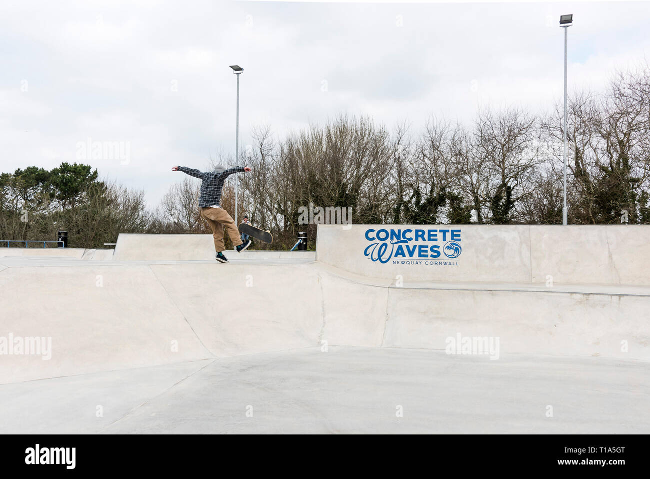 A skateboarder performing a trick at Concrete Waves Skateboard Park in Newqay in Cornwall. Stock Photo