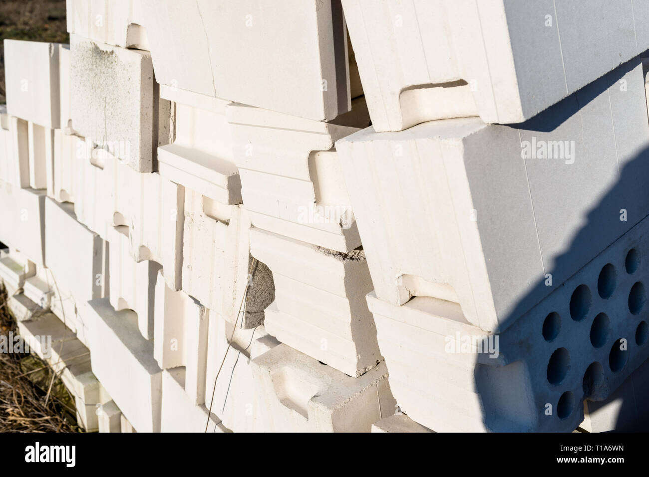 Heap of bricks from cellular concrete, white bricks, hollow bricks with hollow holes inside