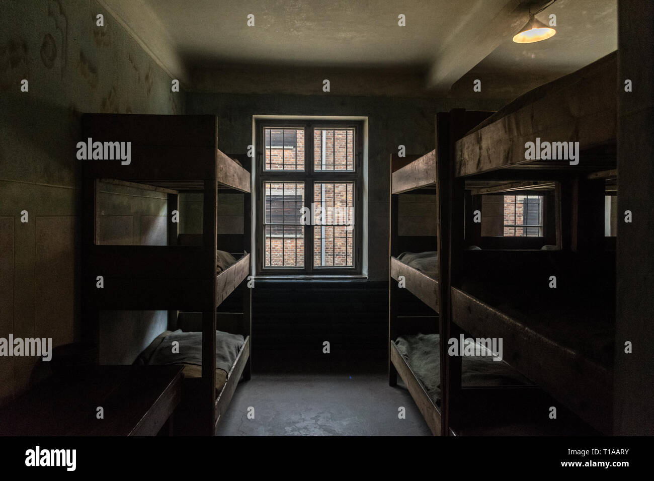 Oswiencim, Poland - September 21, 2019: Sleeping quarters with wooden bunk beds where the prisoners spend the days waiting for a trial at The Nazi Stock Photo