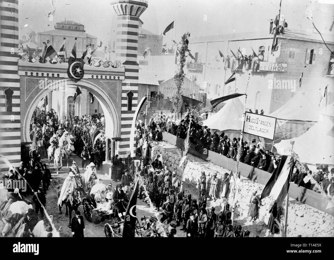 State visit to Jerusalem of Wilhelm II of Germany in 1898. Emperor passing through arch; Hotel D'Europe in background. Emperor and Empress Stock Photo
