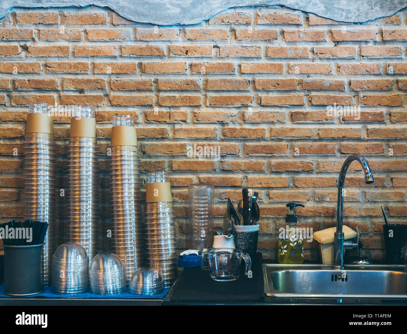 Rows of stacks of upside down transparent plastic coffee cup near