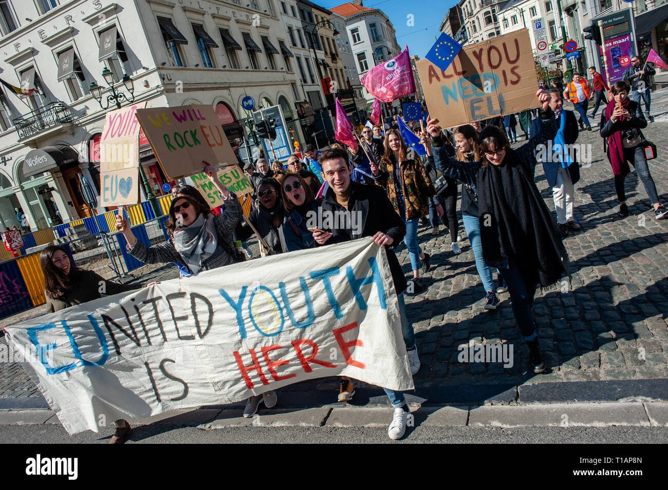 Protesters Are Seen Holding A Banner And Placards While Shouting