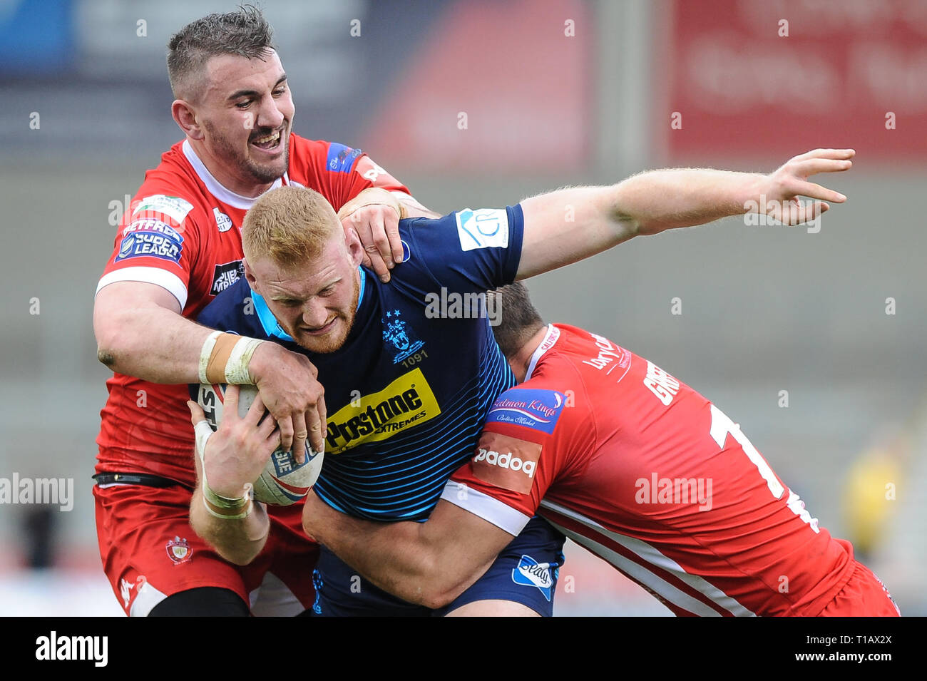 Salford, UK. , . 24 March 2019. AJ Bell Stadium, Salford, England; Rugby League Betfred Super League, Salford Red Devils vs Wigan Warriors; Wigan Warriors Joe Bullock recieves close attention from Adam Walker and George Griffin of Salford Red Devils. Credit: Dean Williams/Alamy Live News Stock Photo
