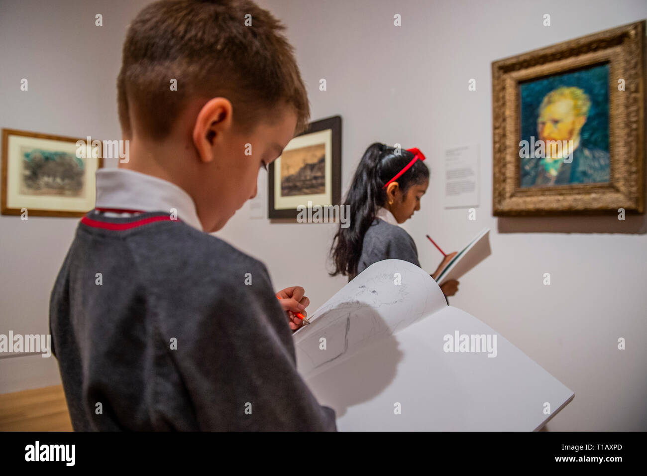 London, UK. 25th March, 2019. Children sketch Self Portrait, 1887, by Vincent Van Gogh - The EY Exhibition: Van Gogh and Britain. This is the first exhibition to take a new look at the artist through his relationship with Britain. It explores how Van Gogh was inspired by British art, literature and and how he in turn inspired British artists, from Walter Sickert to Francis Bacon. Credit: Guy Bell/Alamy Live News Stock Photo
