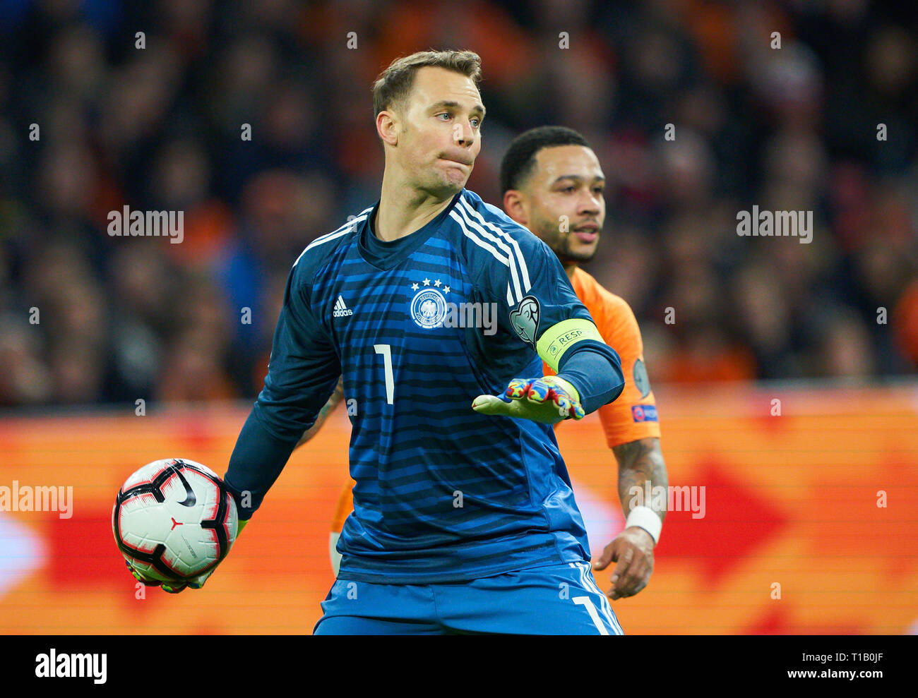 Amsterdam, Netherlands. 24th Mar, 2019. Manuel NEUER, DFB 1 goalkeeper, fights for the ball, catches, catch, hold, defend, action, frame, cut out, reaction, fist, Memphis DEPAY, NL 10 NETHERLANDS - GERMANY 2-3 Important: DFB regulations prohibit any use of photographs as image sequences and/or quasi-video. Qualification for European Championships, EM Quali, 2020 Season 2018/2019, March 24, 2019 in Amsterdam, Netherlands. Credit: Peter Schatz/Alamy Live News Stock Photo