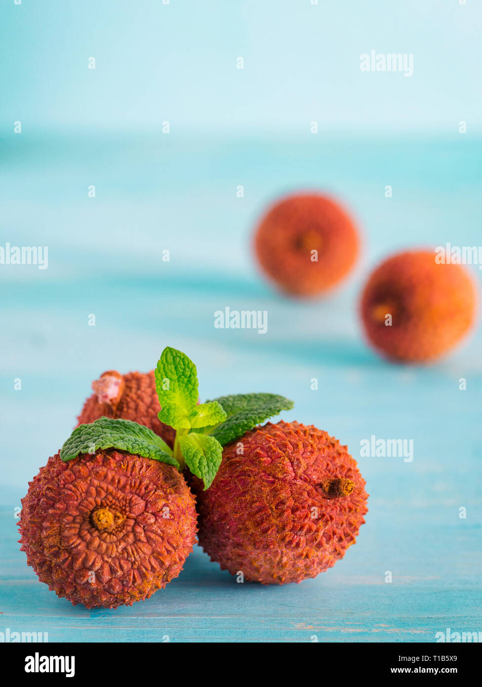 lichee fruit on turquoise wooden background close up Stock Photo