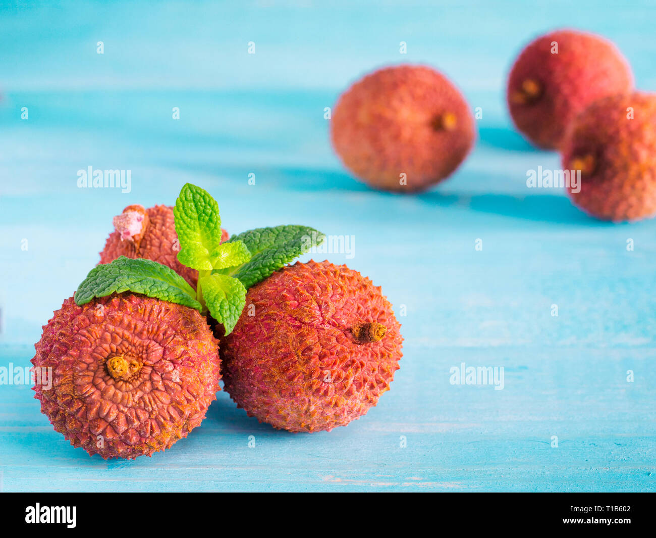 lichee fruit on turquoise wooden background close up Stock Photo