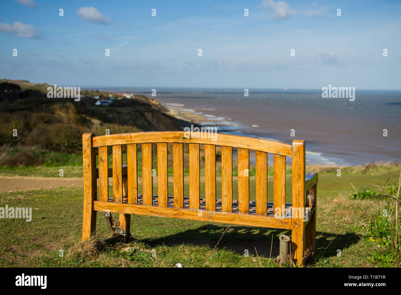Wooden memorial bench on Overstrand cliff top overlooking the Norfolk
