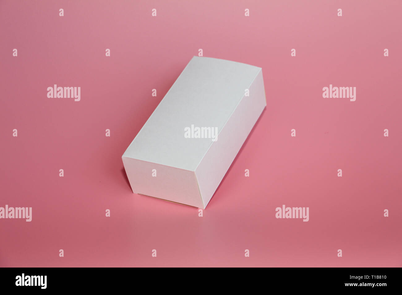 White box lies on a pink background. Horizontal white box. Pink ...